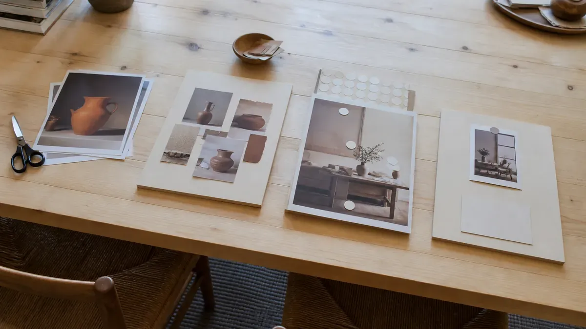 Four table stations with stacked product prints, layered collage cutouts, dotted tag markers, and a blank board label for Cut-Compose-Tag-Pin